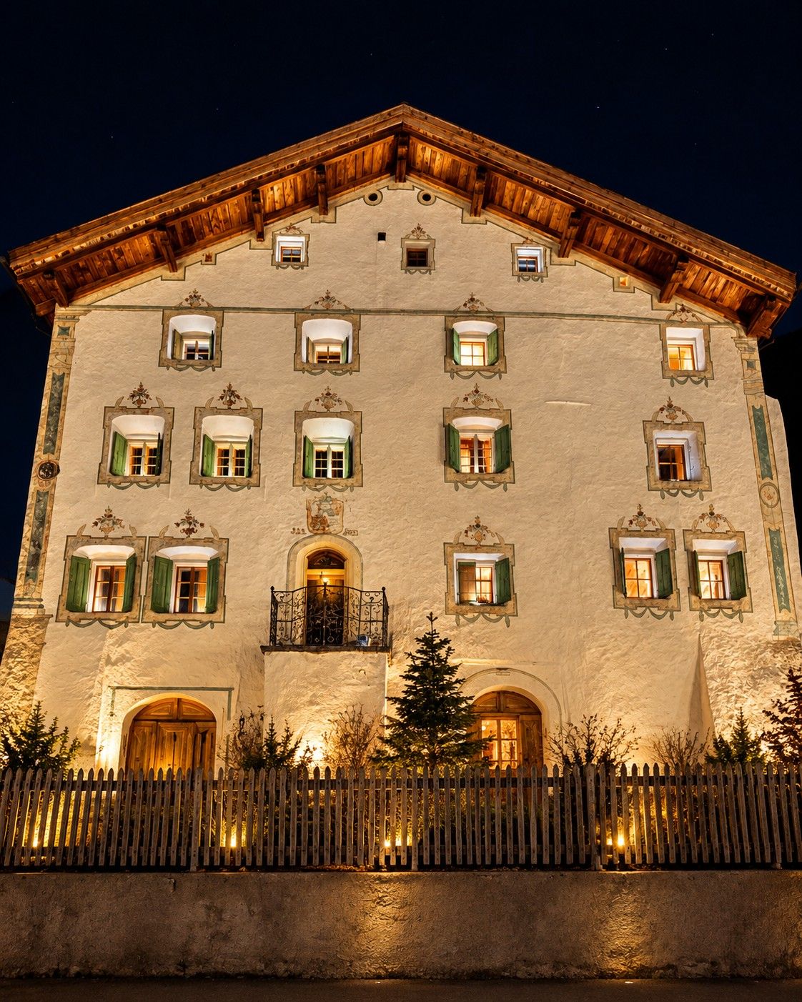 Das Haus an der Dorfstrasse 65 in Filisur bei Nacht, mit bemalter Fassade